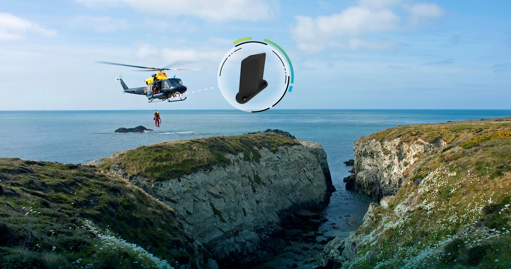 Search and rescue helicopter suspending a person over a waterside cliff with an Antcom 5B antenna